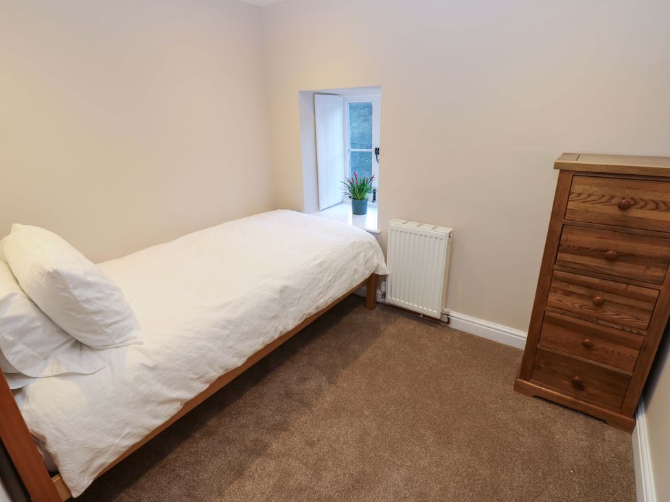 A bedroom with a single bed and a chest of drawers at The Old Dairy in Muker