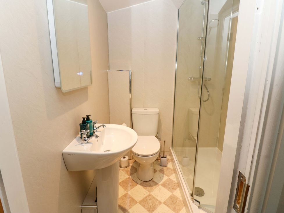 A bathroom with a sink and shower at The Old Dairy in Muker