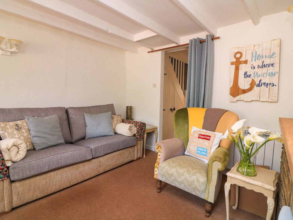 A living room with a sofa and chair at 2 The Square Hope Cove