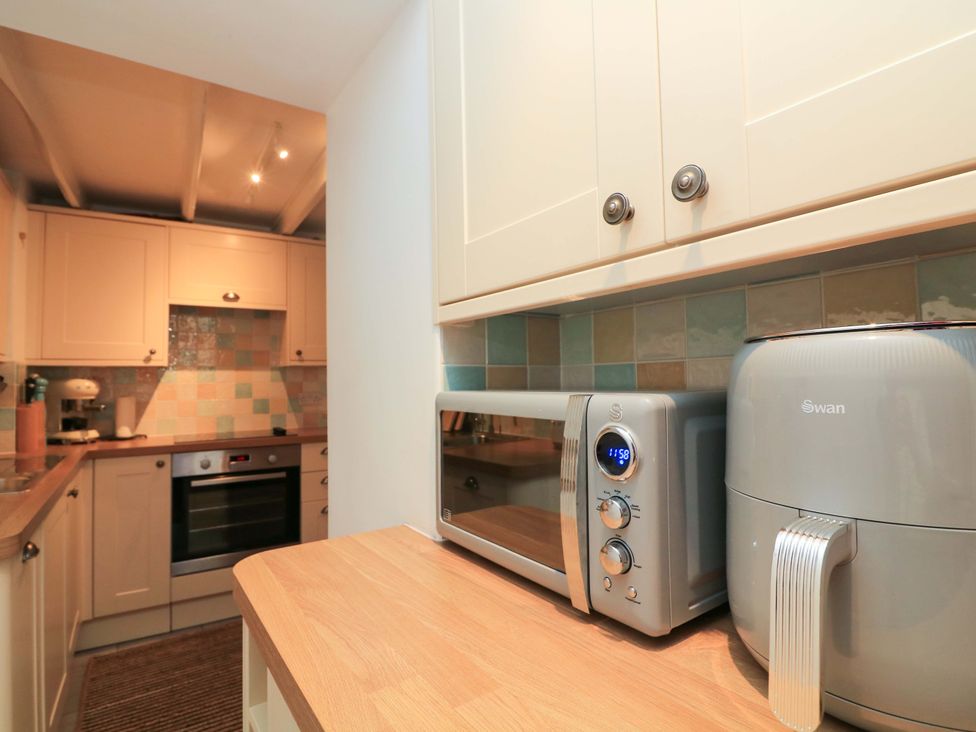 A kitchen with microwave and air fryer in 2 The Square Hope Cove