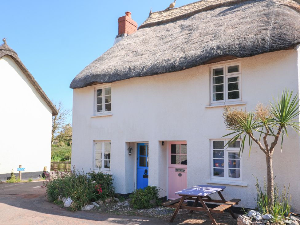 A cottage with a thatched roof and garden at 2 The Square Hope Cove