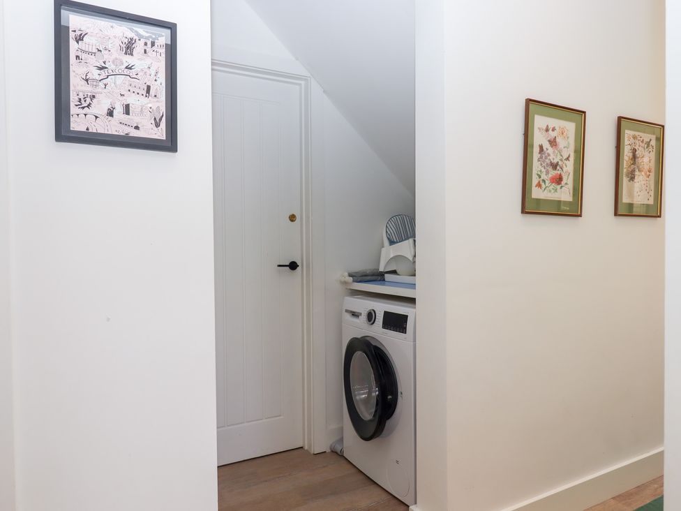 A laundry room with a washing machine at Clova in Brixham