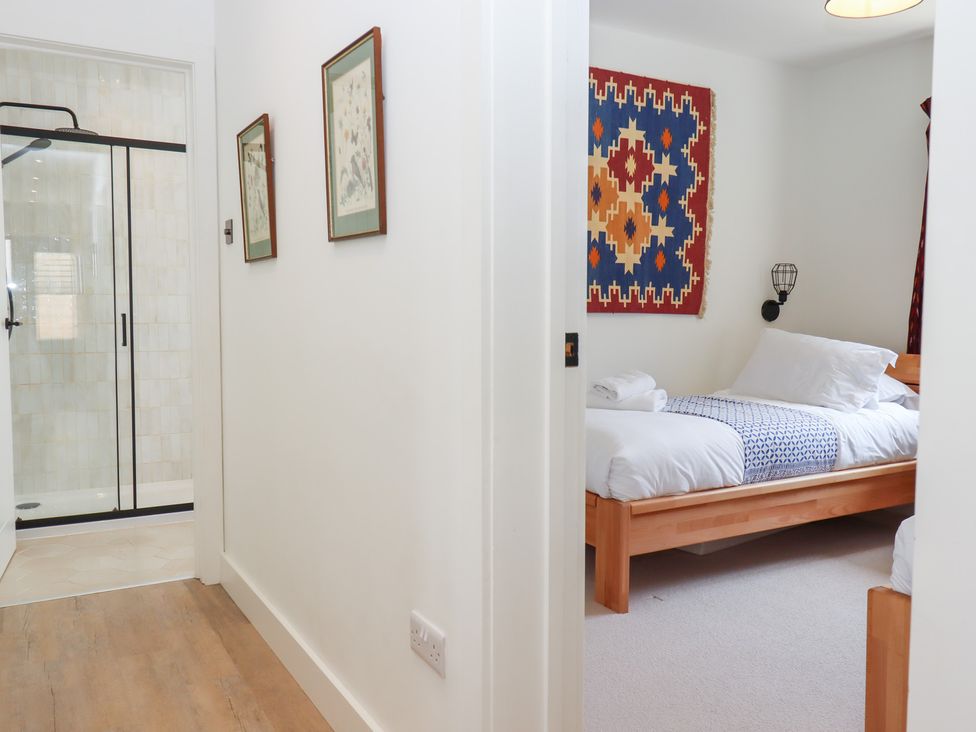 A bedroom with a bed and shower at Clova in Brixham