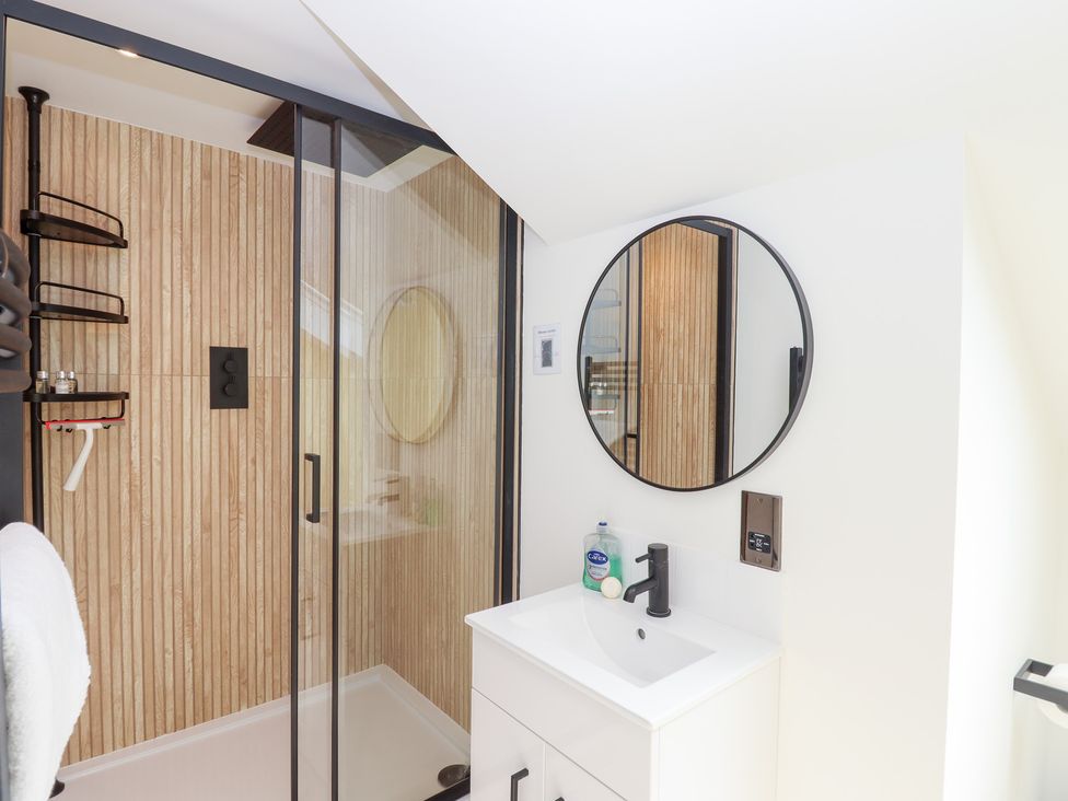 A bathroom with a shower and sink at Clova in Brixham