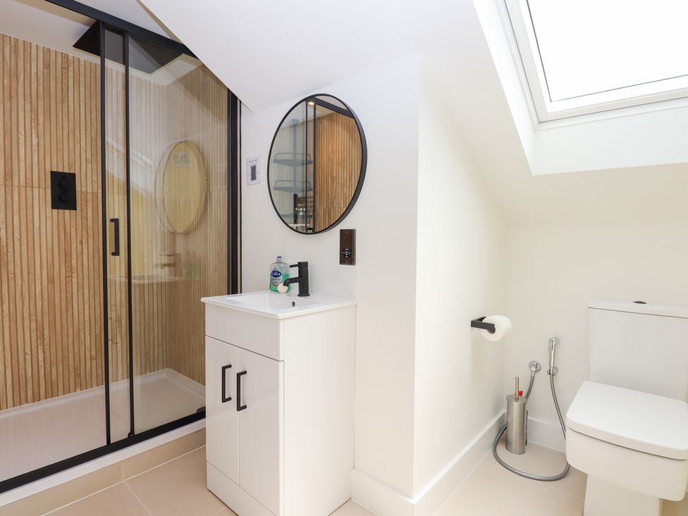 A bathroom with a shower, sink, and toilet at Clova, Brixham