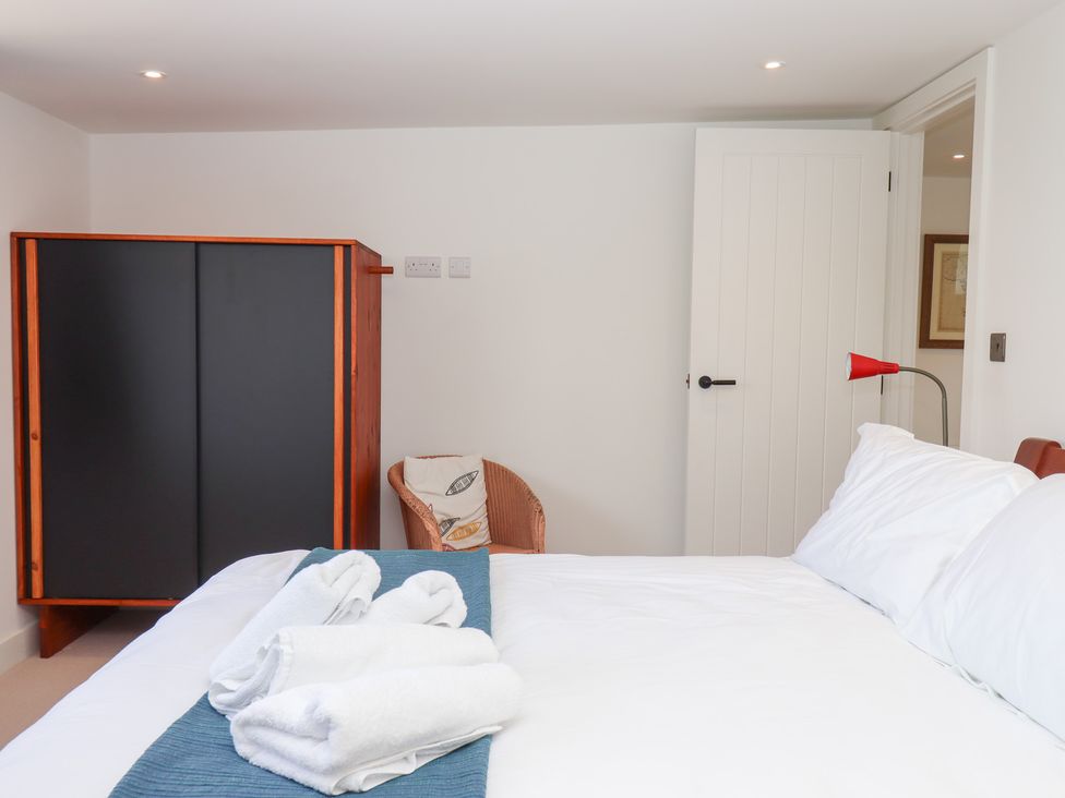 A bedroom with a bed and wardrobe at Clova in Brixham