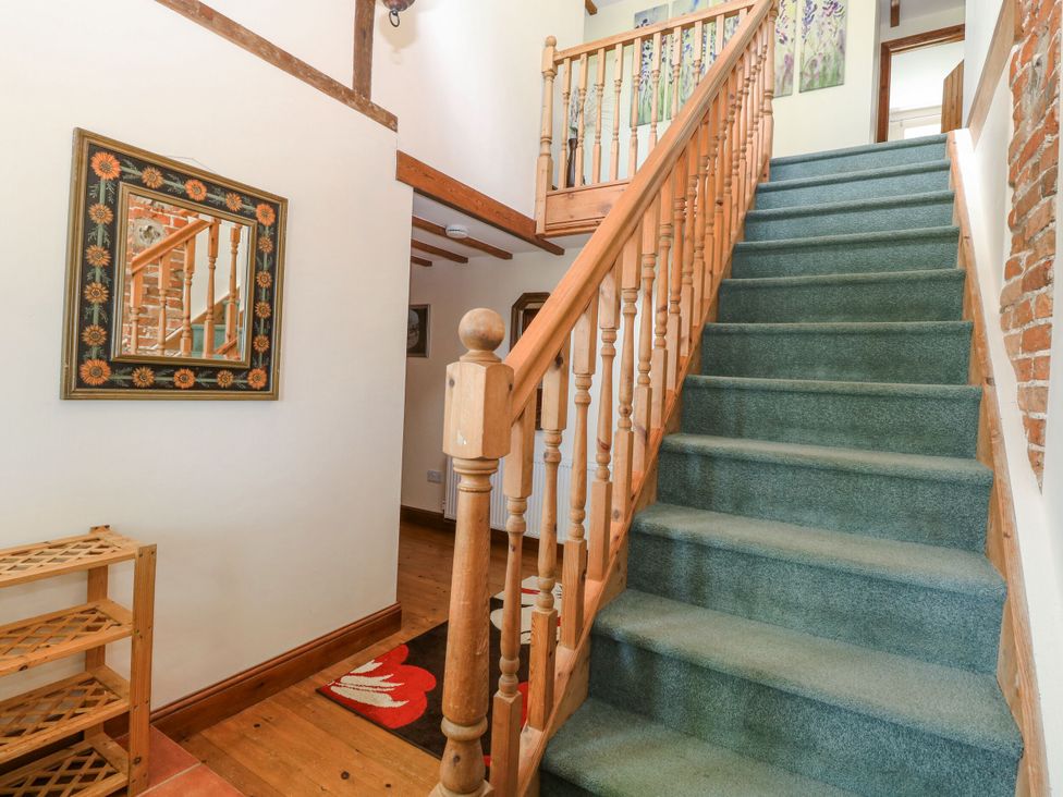 A staircase leading to the upper floor at Lakeside Barn Aylsham