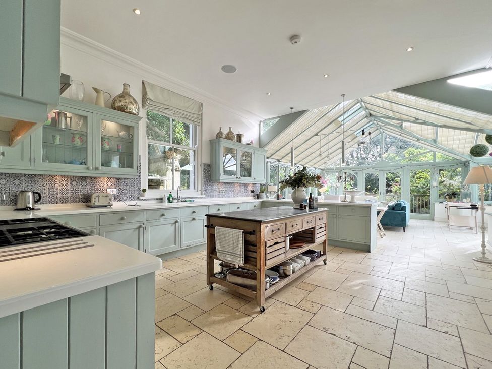 A kitchen with cabinets and a large island at Trenare in Truro