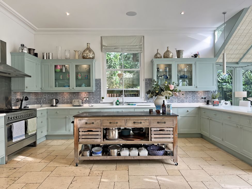 A kitchen with cabinets and an island at Trenare in Truro