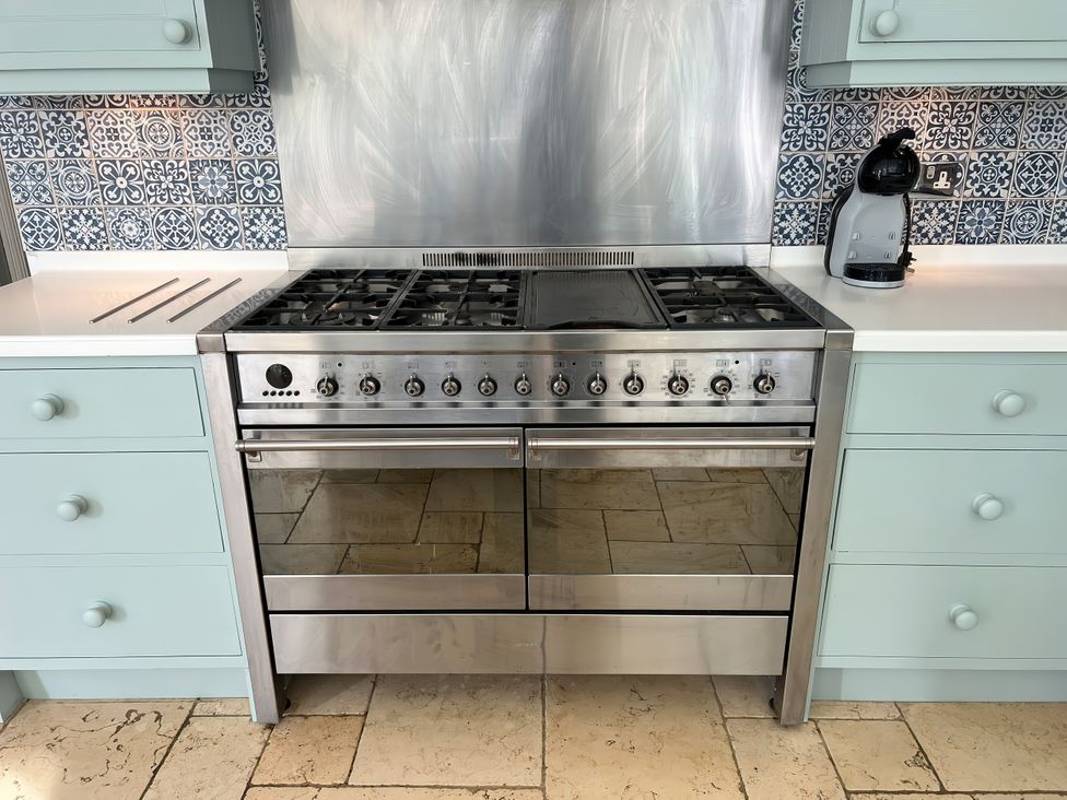 A stove with an oven and coffee maker at Trenare in Truro