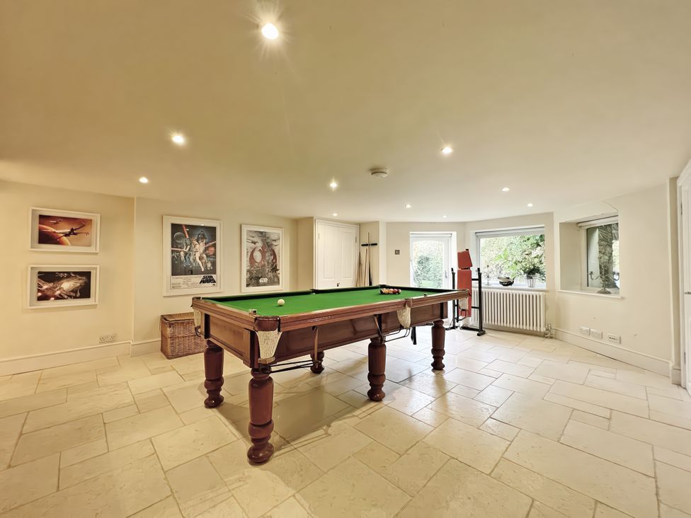 A game room with a pool table and framed posters at Trenare in Truro