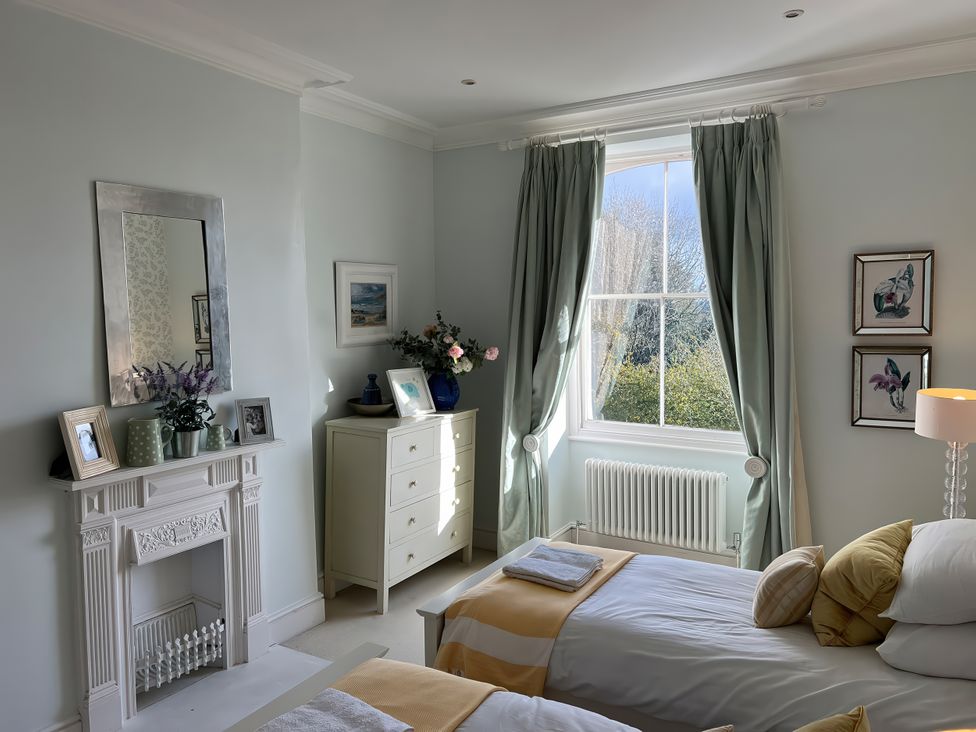 A bedroom with two beds and a window at Trenare in Truro