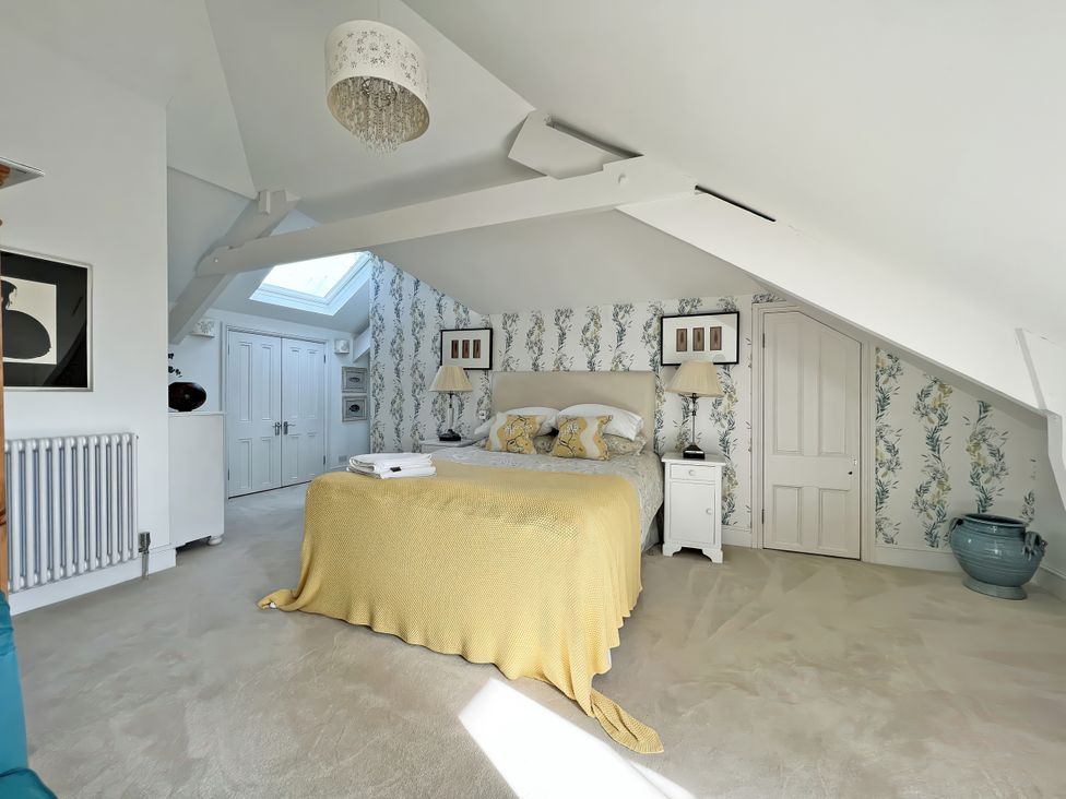 A bedroom with a bed and bedside table at Trenare in Truro