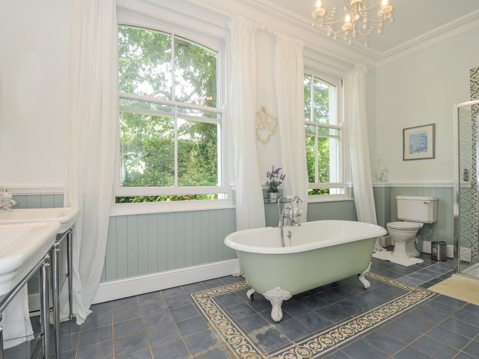 A bathroom with a bathtub, toilet, and shower at Trenare in Truro