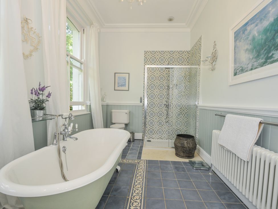 A bathroom with a bathtub and shower at Trenare in Truro