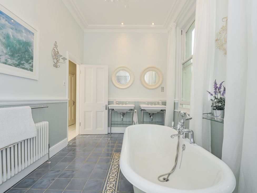 A bathroom with a bathtub and sinks at Trenare in Truro