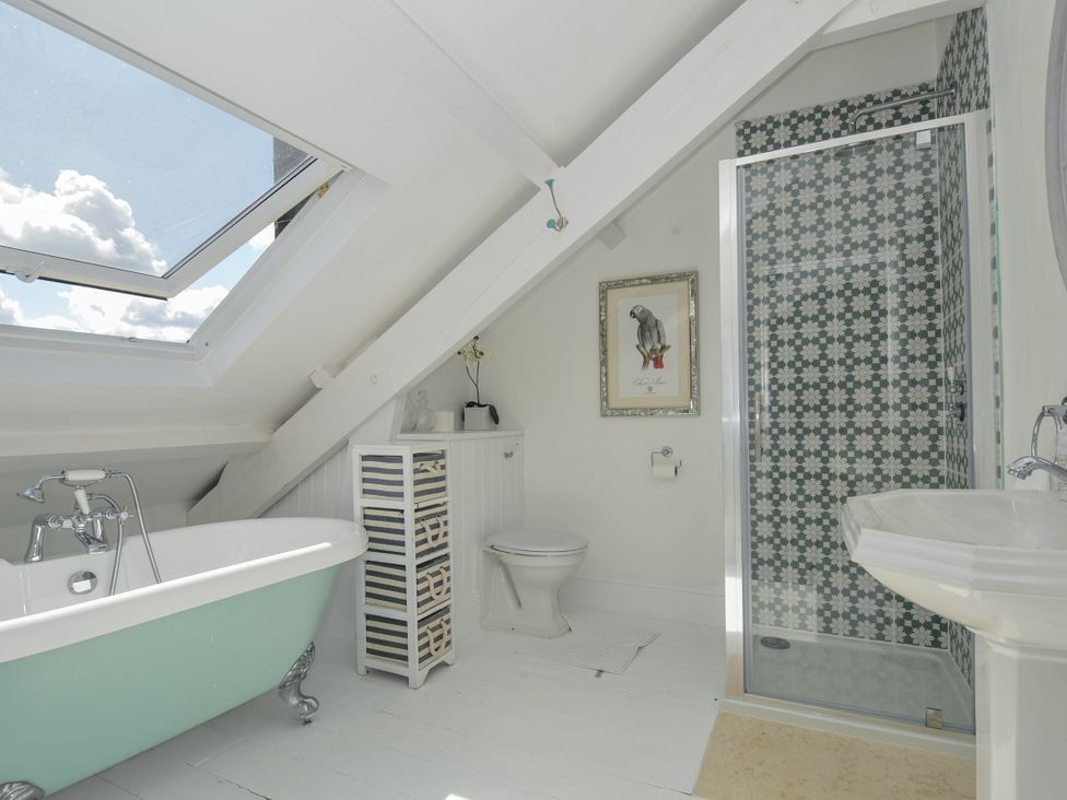 A bathroom with a bathtub, shower, toilet, and sink at Trenare in Truro