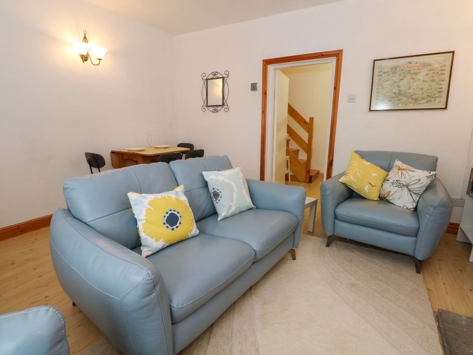 A living room with a sofa and armchair at Holme Cottage, Hebden Bridge