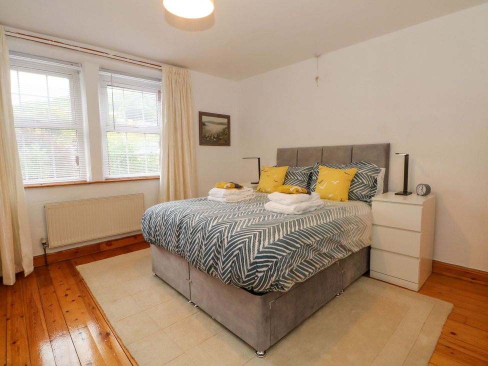 A bedroom with a double bed and nightstand at Holme Cottage Hebden Bridge