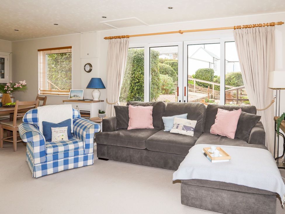 A living room with sofa and armchair at Machroes Cottage Pwllheli