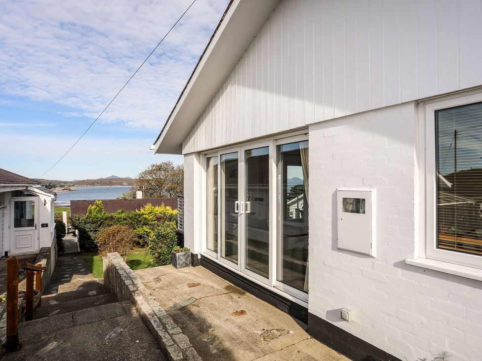 Exterior view of a house with steps and garden at Machroes Cottage Pwllheli