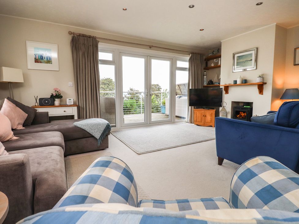 A living room with a sofa and television at Machroes Cottage in Bwlchtocyn near Abersoch