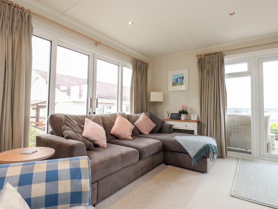 A living room with a sofa and table at Machroes Cottage Bwlchtocyn near Abersoch