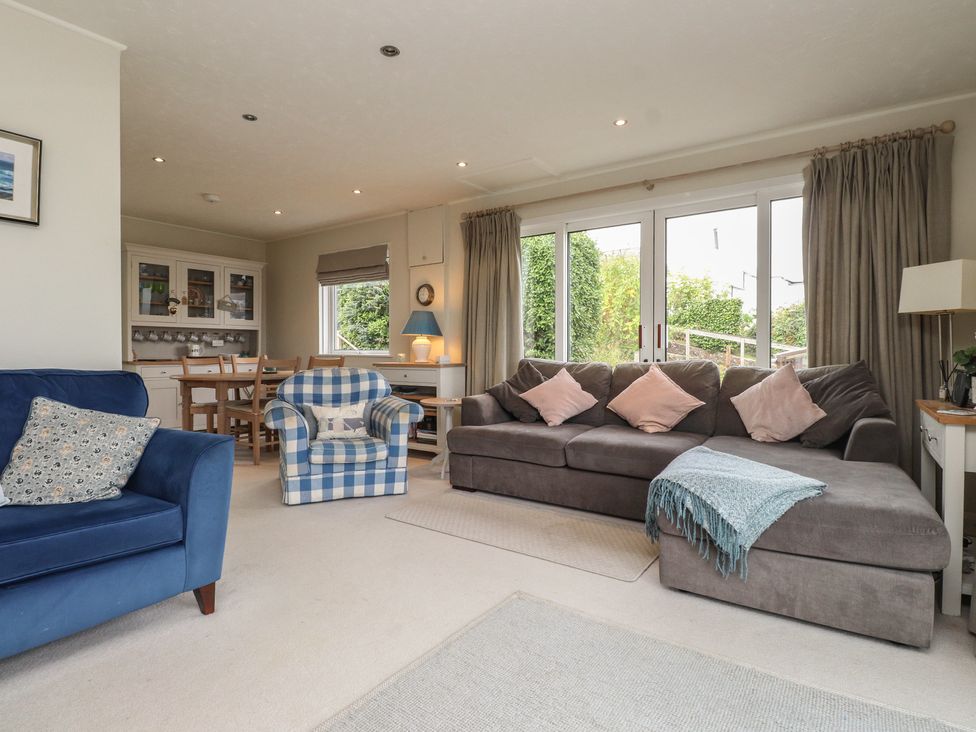 A living room with sofa and dining area at Machroes Cottage Bwlchtocyn near Abersoch