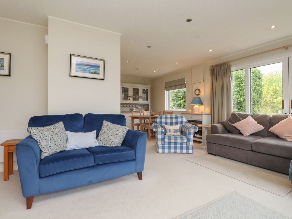 A living room with a blue sofa and armchair at Machroes Cottage Bwlchtocyn near Abersoch