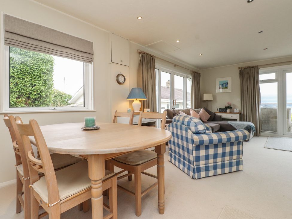 A living room with a table and sofa at Machroes Cottage Bwlchtocyn near Abersoch