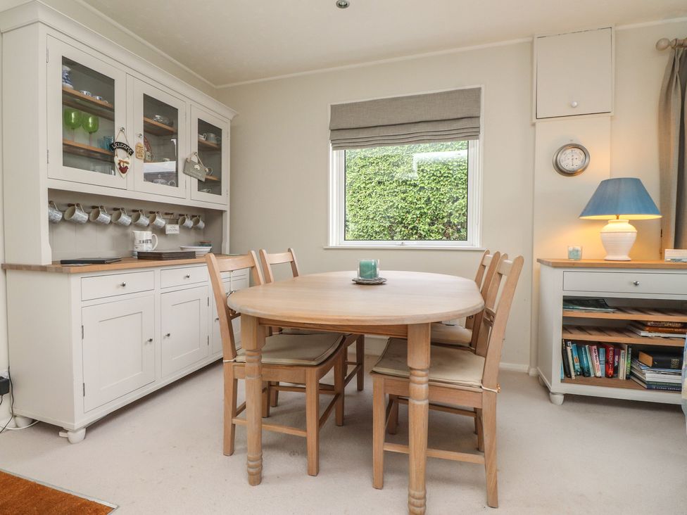 A dining room with a table and chairs at Machroes Cottage Bwlchtocyn near Abersoch