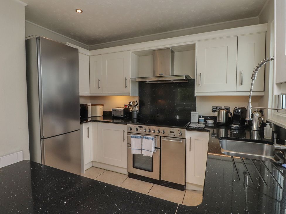 A kitchen with appliances and counter space at Machroes Cottage Bwlchtocyn near Abersoch