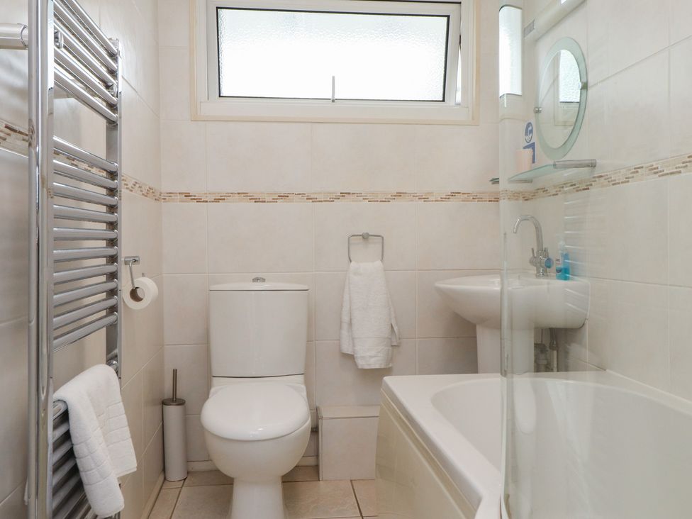 A bathroom with a toilet, sink, and shower at Machroes Cottage Bwlchtocyn near Abersoch