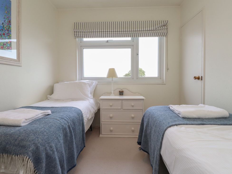 A bedroom with two beds and a dresser at Machroes Cottage Bwlchtocyn near Abersoch
