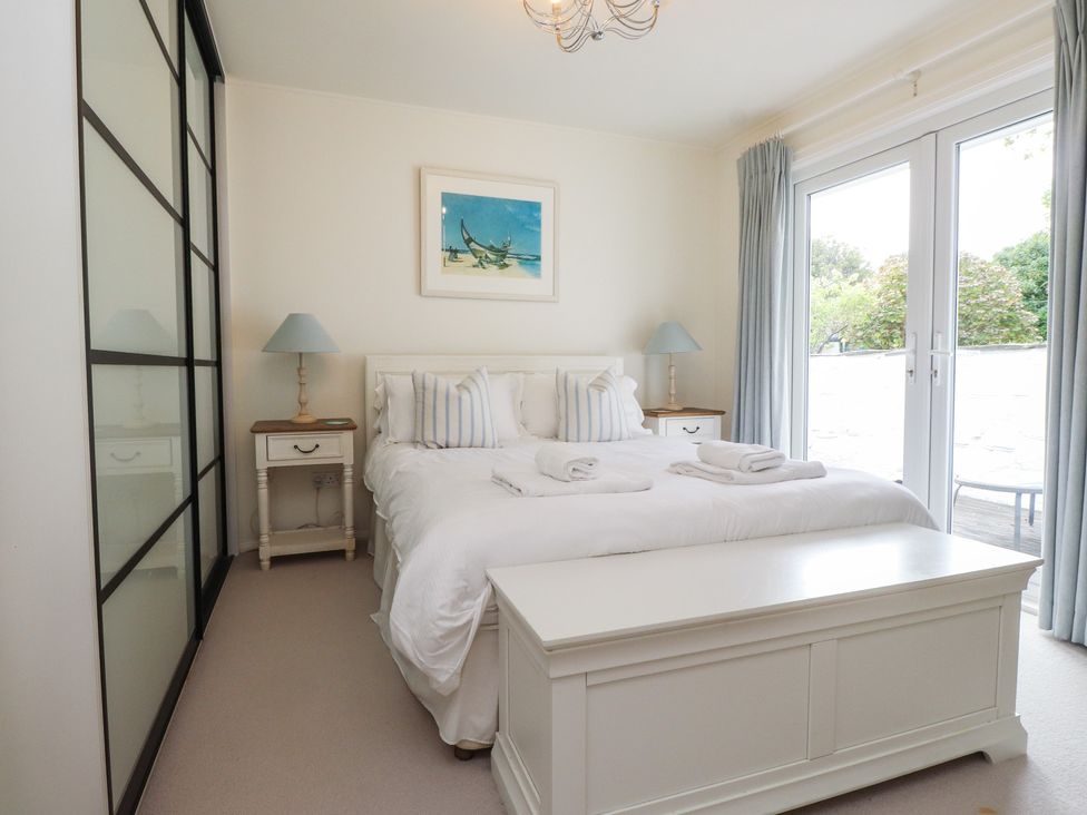 A bedroom with a bed and bedside tables at Machroes Cottage Bwlchtocyn near Abersoch