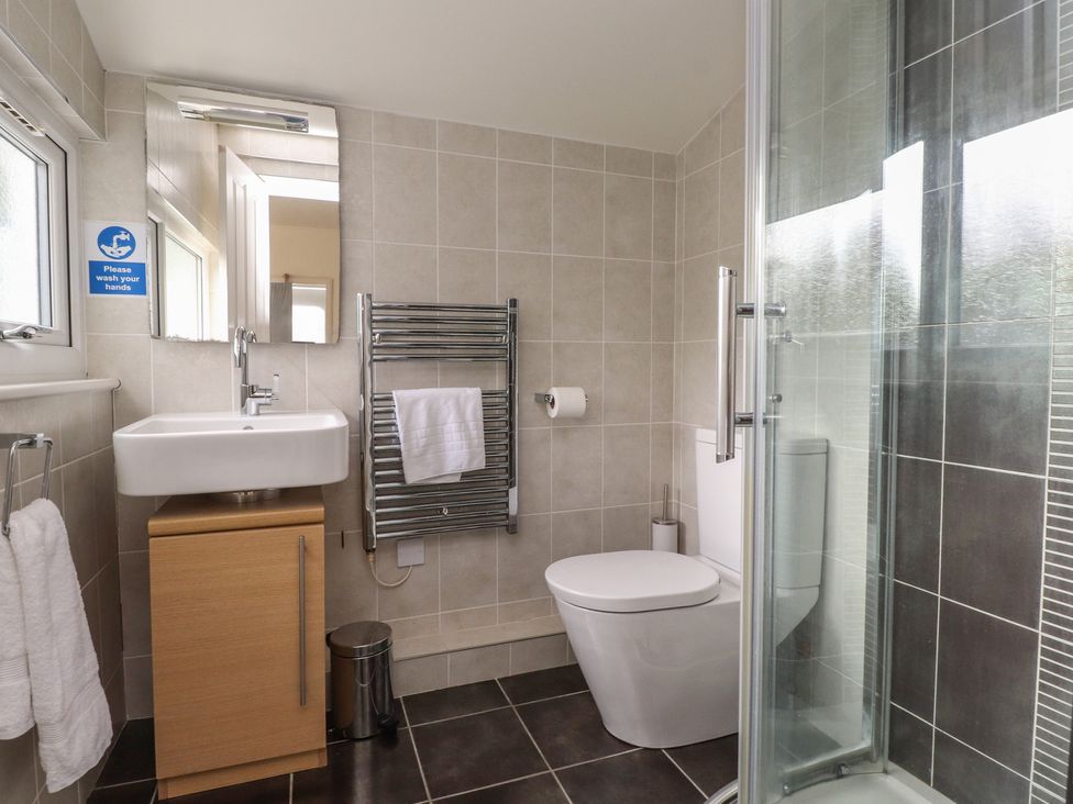 A bathroom with a sink and shower at Machroes Cottage near Bwlchtocyn Abersoch