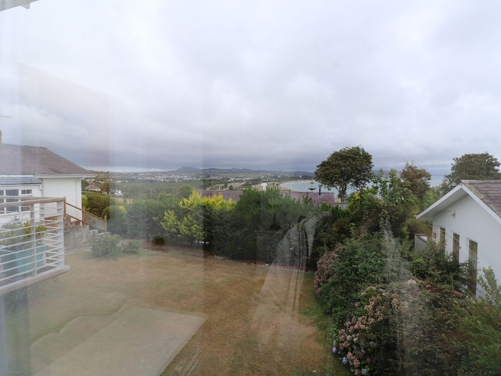 A garden view with houses and trees at Machroes Cottage in Bwlchtocyn near Abersoch