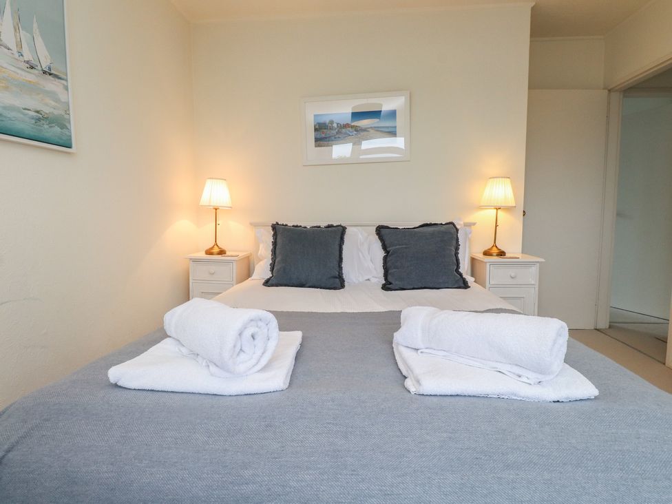 A bedroom with a double bed and pillows at Machroes Cottage near Bwlchtocyn near Abersoch