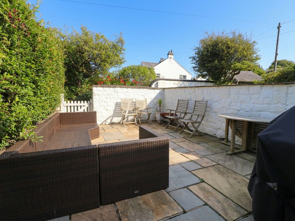 A garden with seating area and patio stones at Machroes Cottage Bwlchtocyn near Abersoch