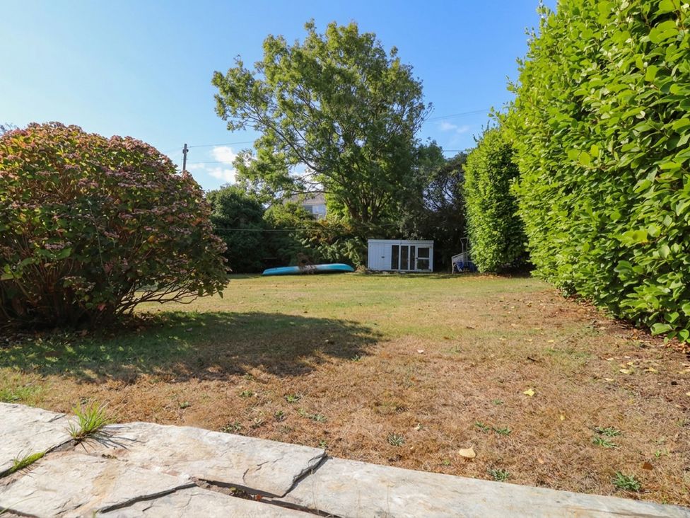 A garden with a lawn and a shed at Machroes Cottage in Bwlchtocyn near Abersoch