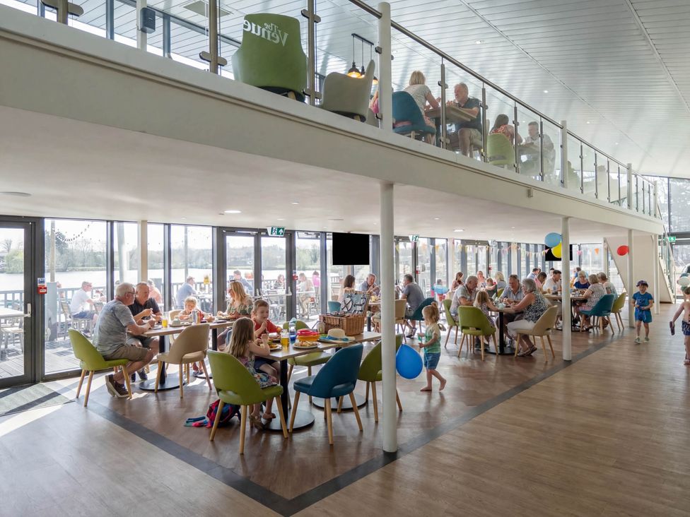 A dining area with tables and chairs filled with people at Celestial Skylight - Billing Aquadrome