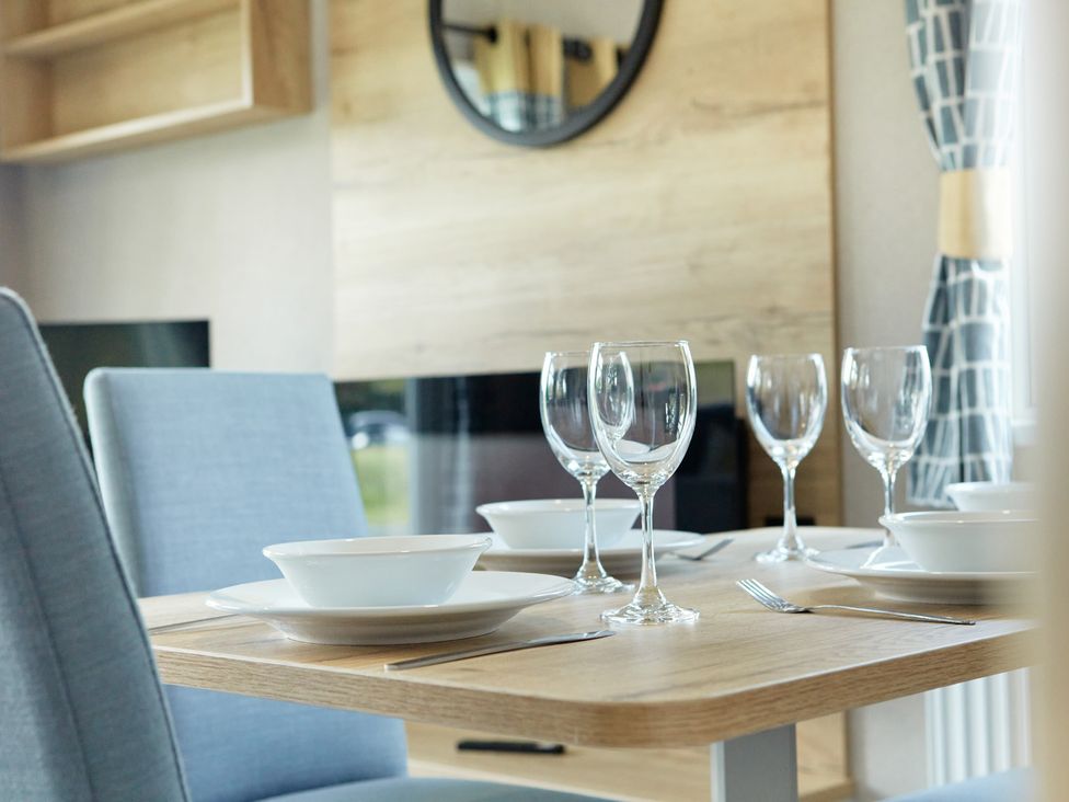 A dining room with a table set for a meal at Meadowview - Billing Aquadrome