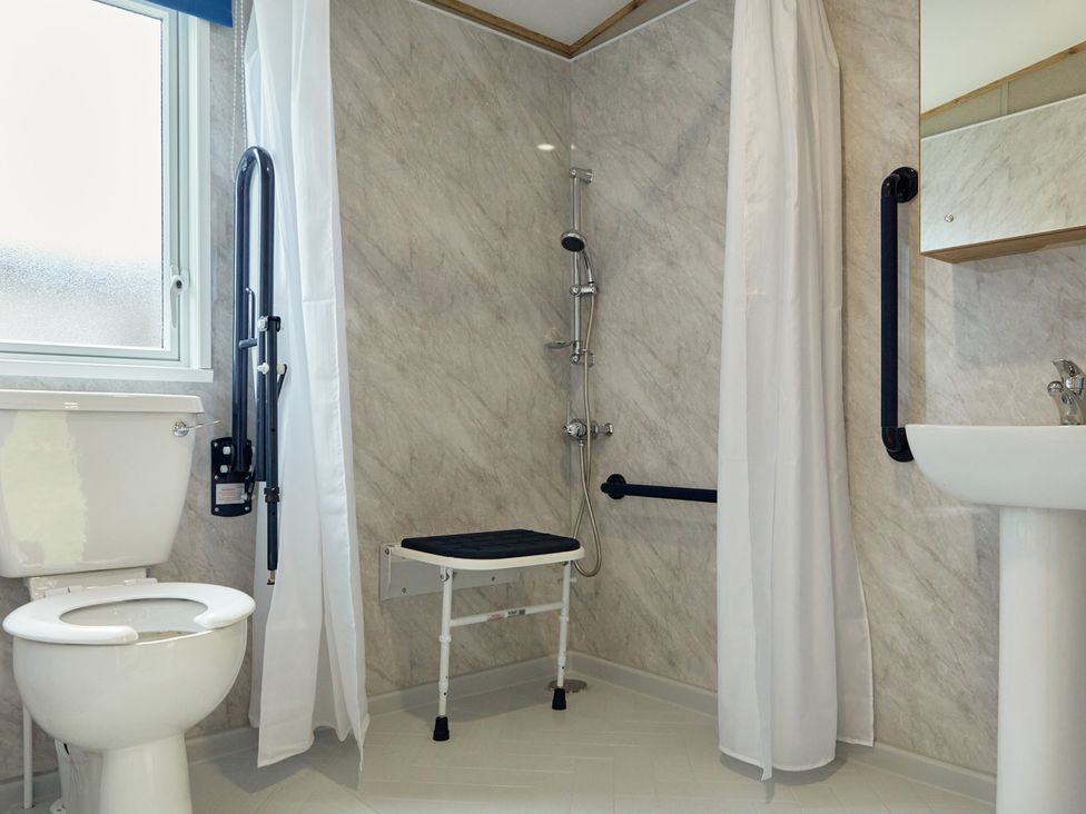 A bathroom with toilet, sink, and shower at Meadowview - Billing Aquadrome