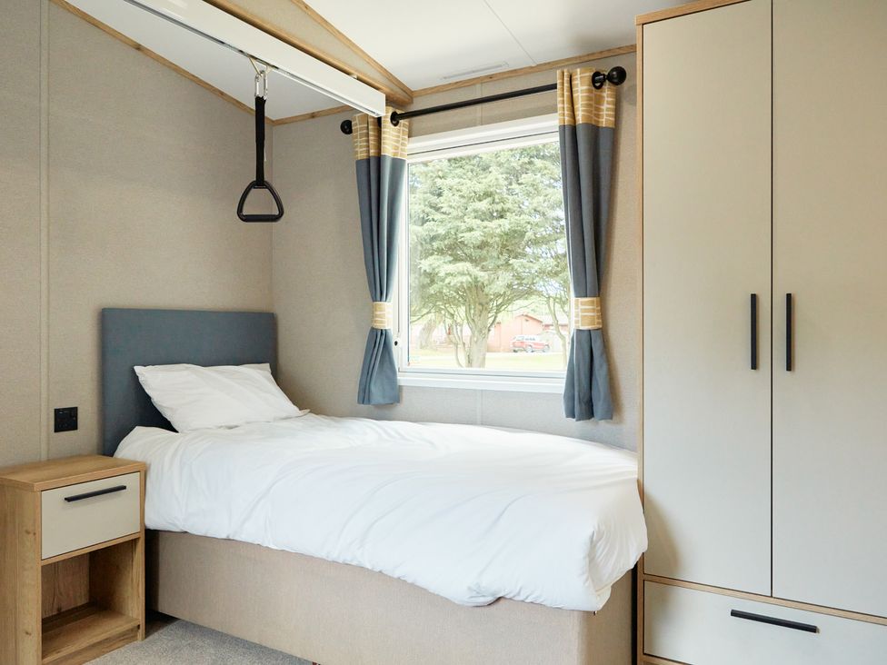 A bedroom with a bed and a window at Meadowview - Billing Aquadrome