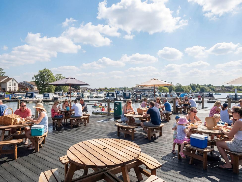 An outdoor area with tables and umbrellas at Moonlit Skylight - Billing Aquadrome