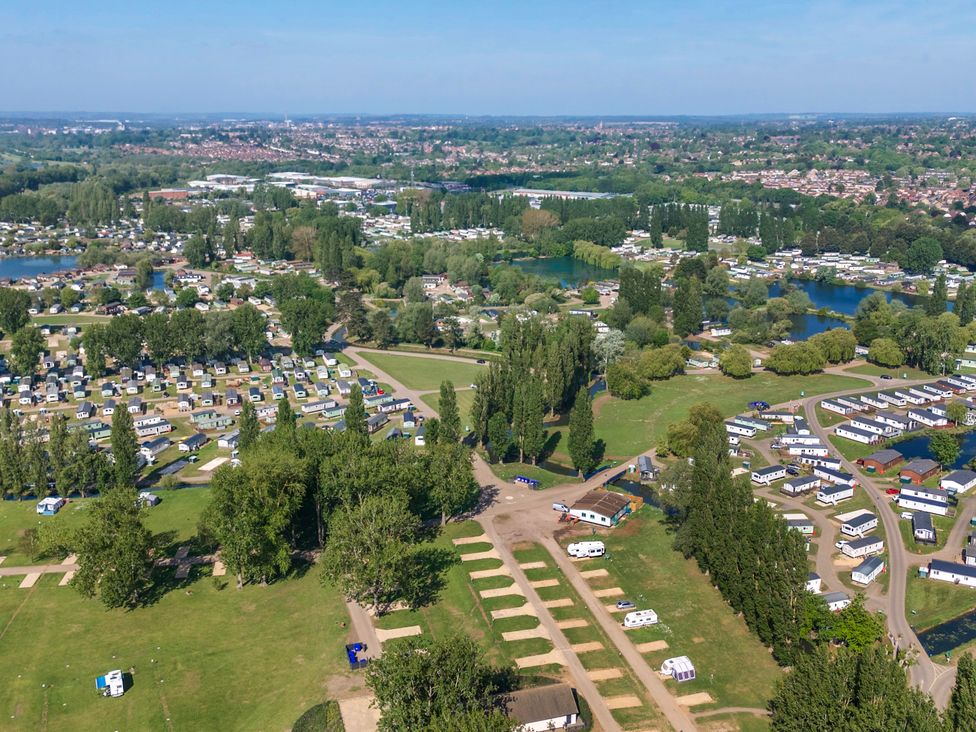 An aerial view of a large holiday park with caravans lakes trees and roads at Brookside Bliss - Billing Aquadrome in Billing Aquadrome Holiday Park