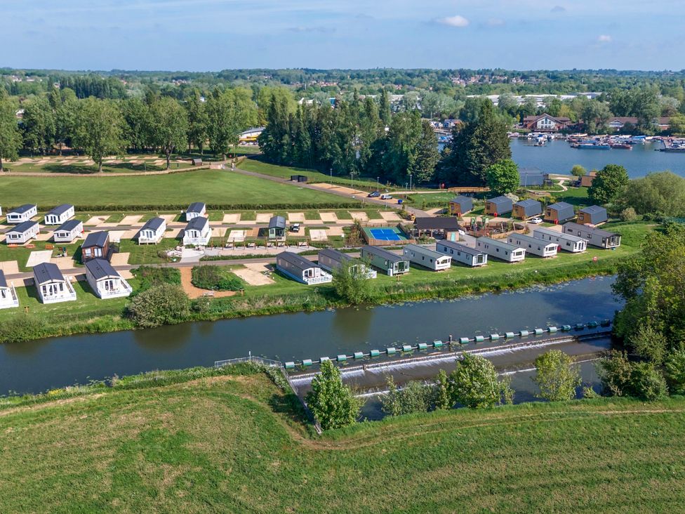 An aerial view of a holiday park with mobile homes near water and trees at Brookside Bliss Billing Aquadrome