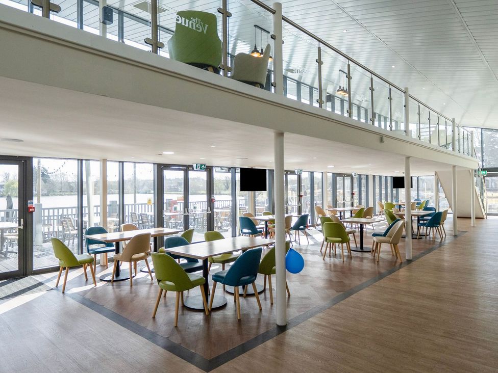 A dining area with tables and chairs at Brookside Bliss - Billing Aquadrome