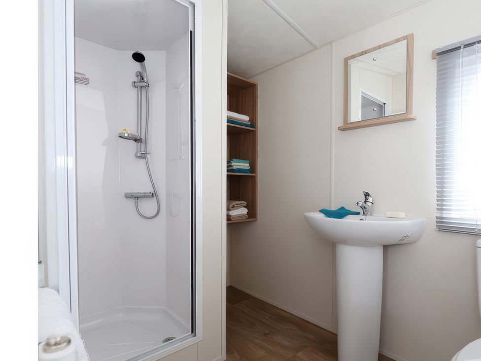 A bathroom with a shower and sink at Mariner's Meadow - Hayling Island