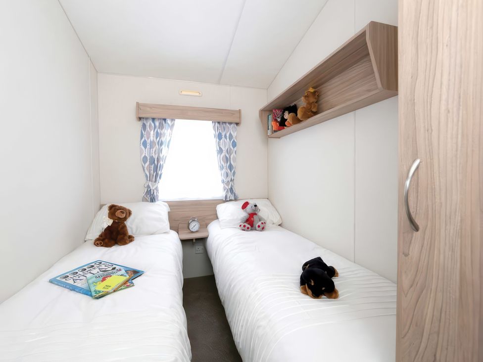 A bedroom with twin beds and stuffed animals at Mariner's Meadow - Hayling Island